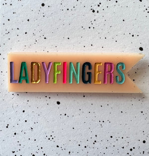 Ladyfingers Pink Acrylic Banner Pin
